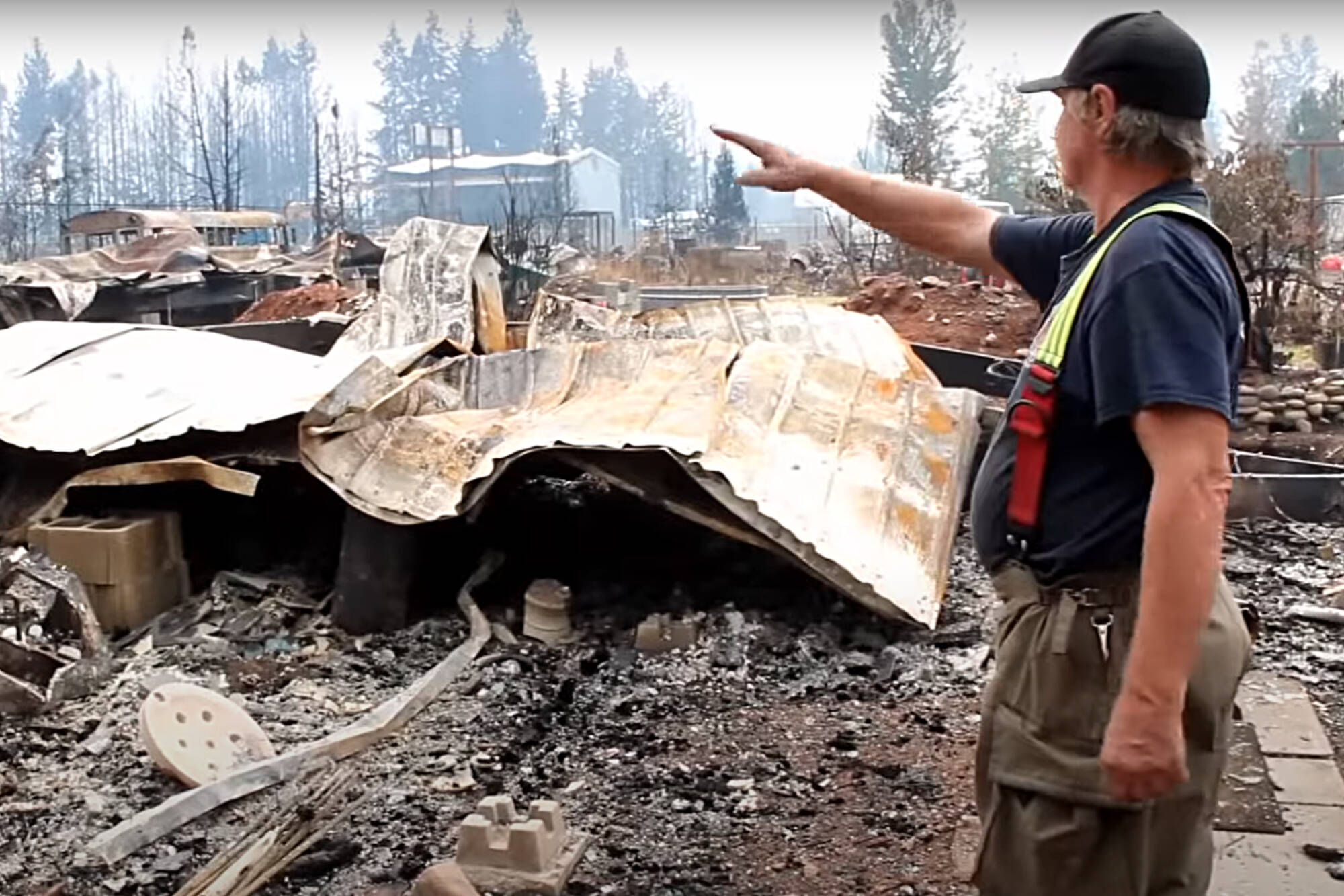 Scotch Creek/Lee Creek firefighter Darren Reynolds looks over the remains of his North Shuswap home that was destroyed Friday, Aug. 18, by the Bush Creek East wildfire. (CSRD image)
