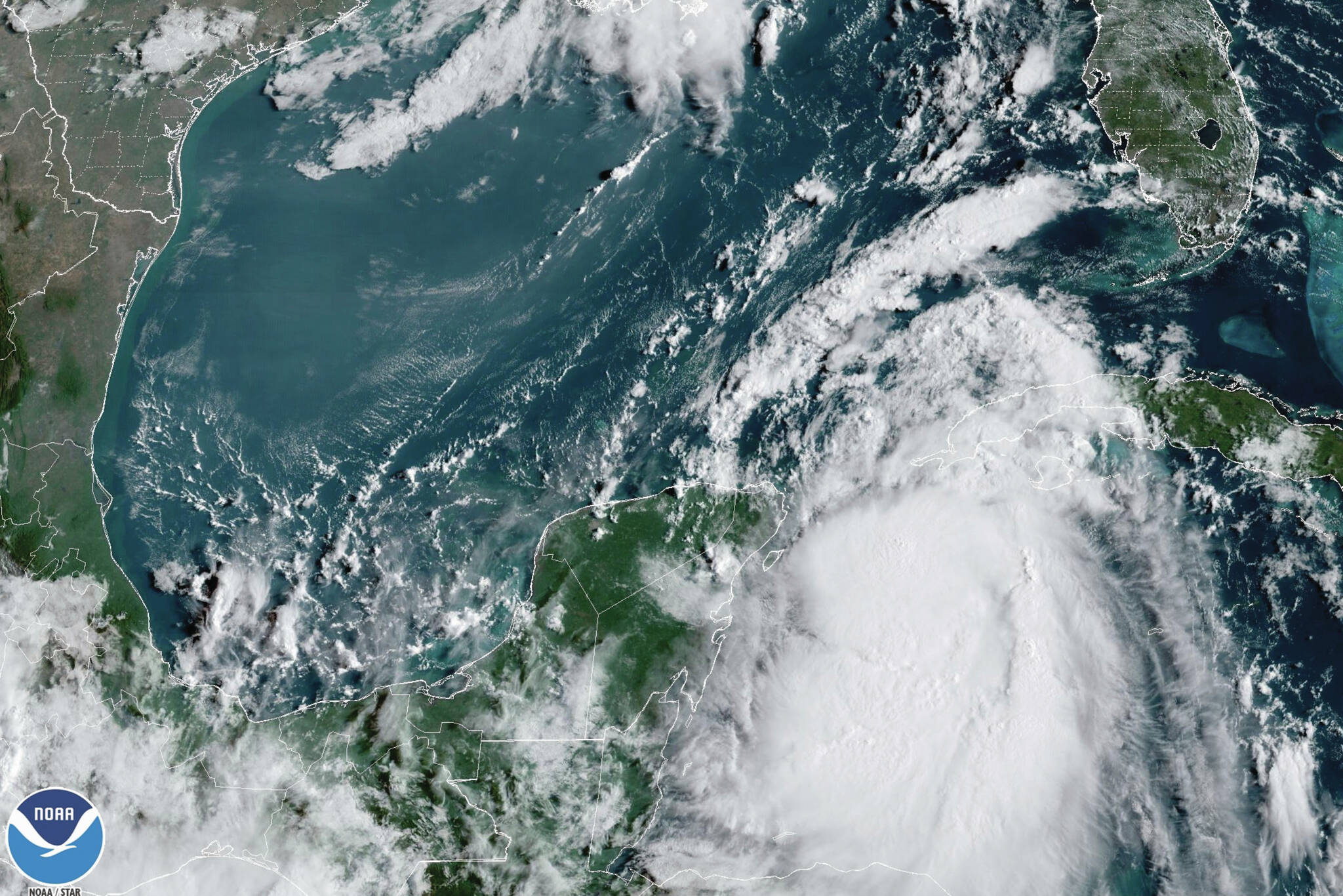 In this Monday, Aug. 28, 2023, 9:41 am ET satellite image provided by the National Oceanic and Atmospheric Administration, Tropical Storm Idalia moves between Mexico’s Yucatan peninsula, left, and Cuba, right. Idalia intensified early Monday and was expected to become a major hurricane before it reaches Florida’s Gulf coast, according to the National Hurricane Center. (NOAA via AP)