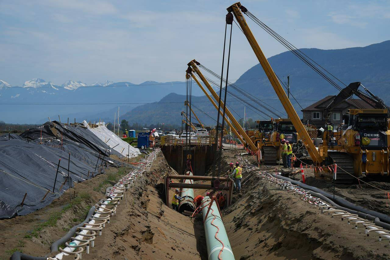 The company behind the Trans Mountain pipeline expansion is worried it won’t complete the project on schedule. Workers lay pipe during construction of the Trans Mountain pipeline expansion on farmland, in Abbotsford, B.C., on Wednesday, May 3, 2023. THE CANADIAN PRESS/Darryl Dyck<