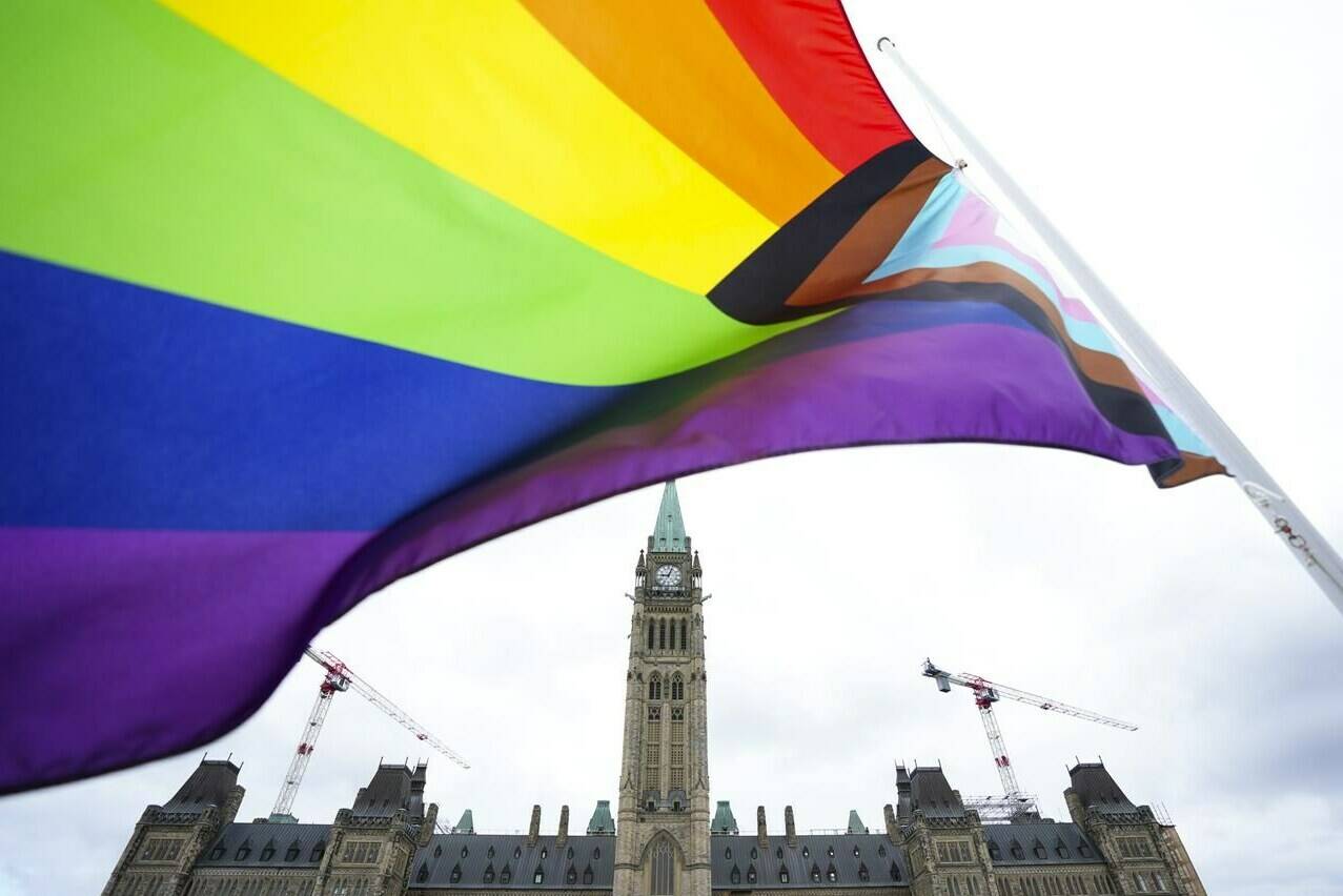 Canada is warning members of the LGBTQ+ community that they may face discrimination if they travel to some places in the United States. A Pride flag flies on Parliament Hill in Ottawa on Thursday, June 8, 2023. THE CANADIAN PRESS/Sean Kilpatrick