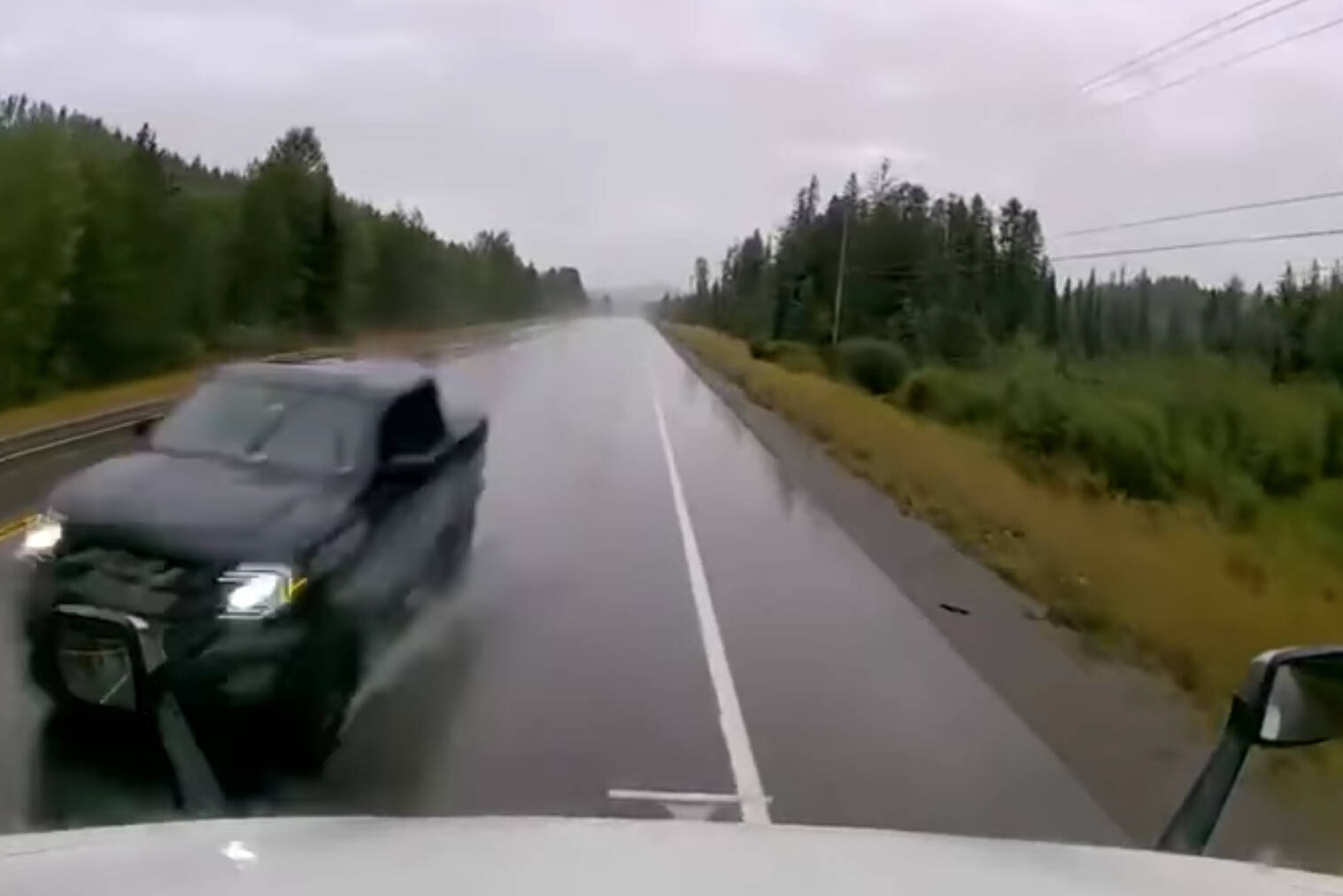 A pickup truck narrowly avoided a head on collision thanks to the quick reaction of a transport truck driver, who steered off Highway 3 near Galloway. Screenshot from Elk Valley RCMP video.