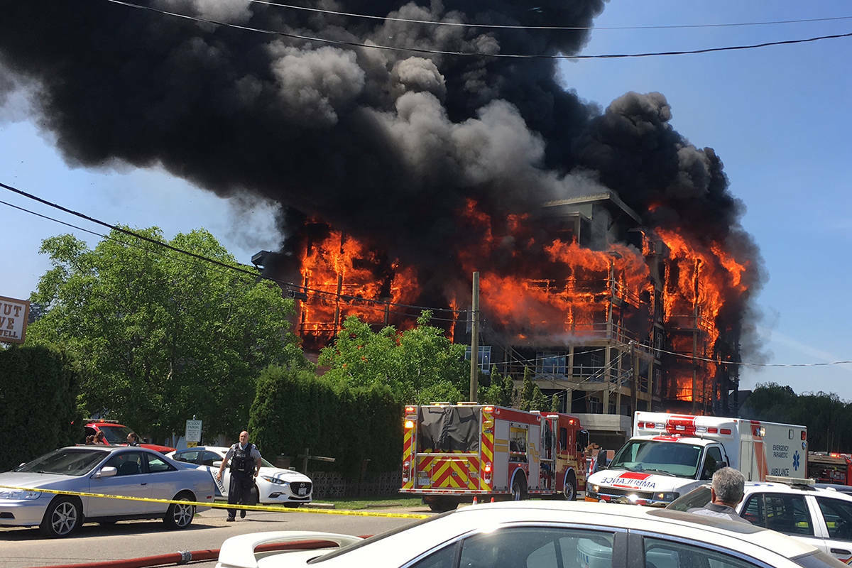 The under-construction Water’s Edge building on Truswell Road in Kelowna engulfed in flames moments before it collapsed on July 8, 2017. (File)