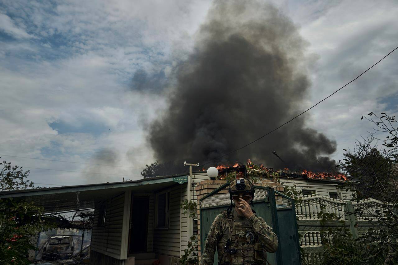A Ukrainian soldier passes by a burning house after the Russian shelling close to the front line in Seversk, Donetsk region, Ukraine, Friday, Sept. 1, 2023. THE CANADIAN PRESS/AP-Libkos