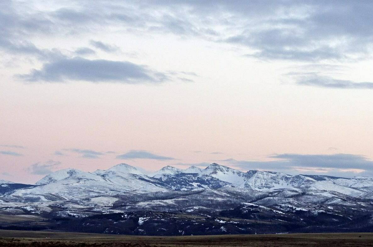 FILE - In this March 25, 2016, file photo, the sun sets over the Badger-Two Medicine area near Browning, Mont. A Louisiana company will relinquish the last remaining oil and gas lease on land near Montana's Glacier National Park that's sacred to Native Americans in the U.S. and Canada, under a legal agreement announced Friday, Sept. 1, 2023, that would resolve a decades-long dispute. (Greg Lindstrom/Flathead Beacon via AP, File)