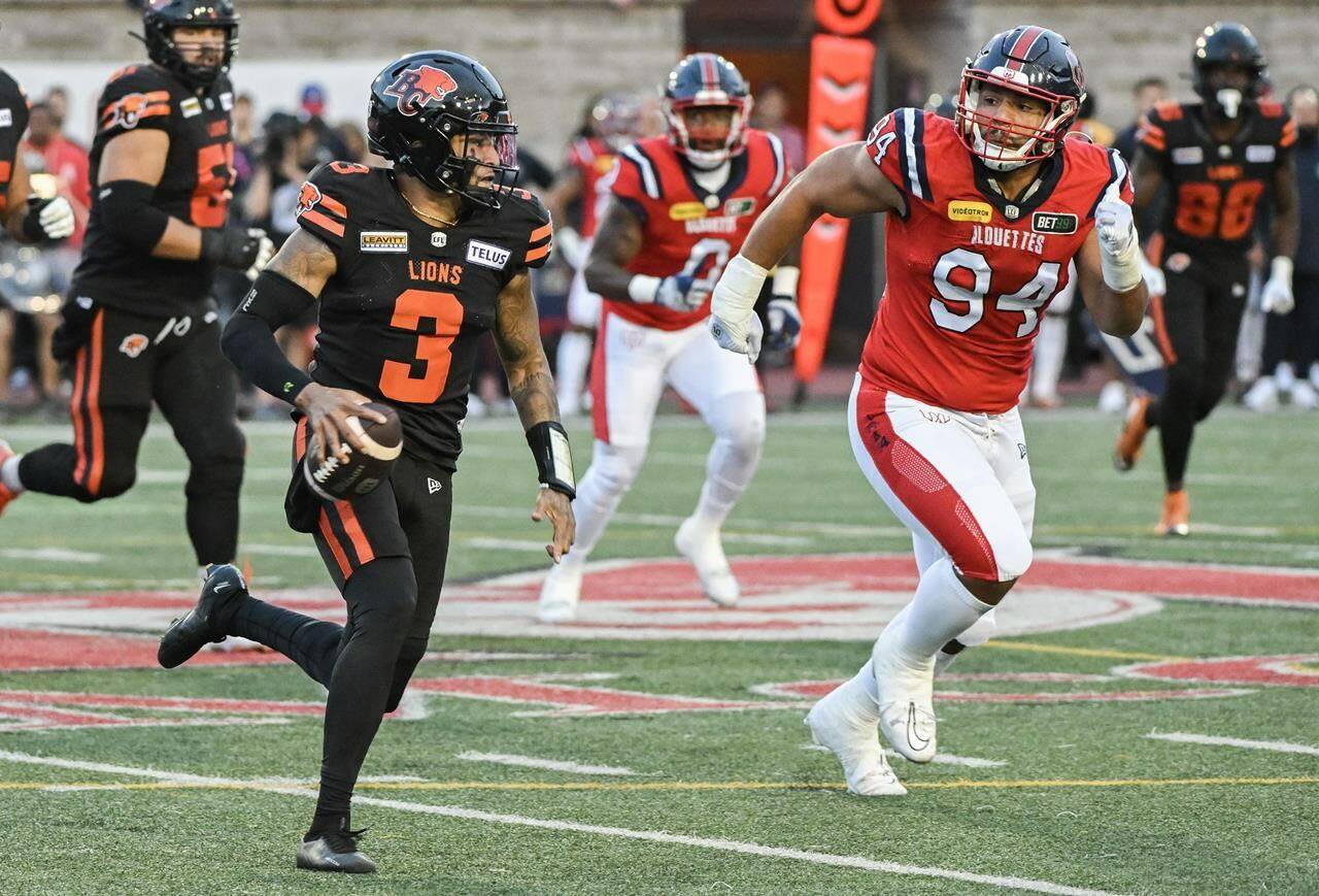 B.C. Lions quarterback Vernon Adams Jr. (3) is pursued by Montreal Alouettes’ Mustafa Johnson (94) during first half CFL football action in Montreal, Saturday, September 2, 2023. THE CANADIAN PRESS/Graham Hughes