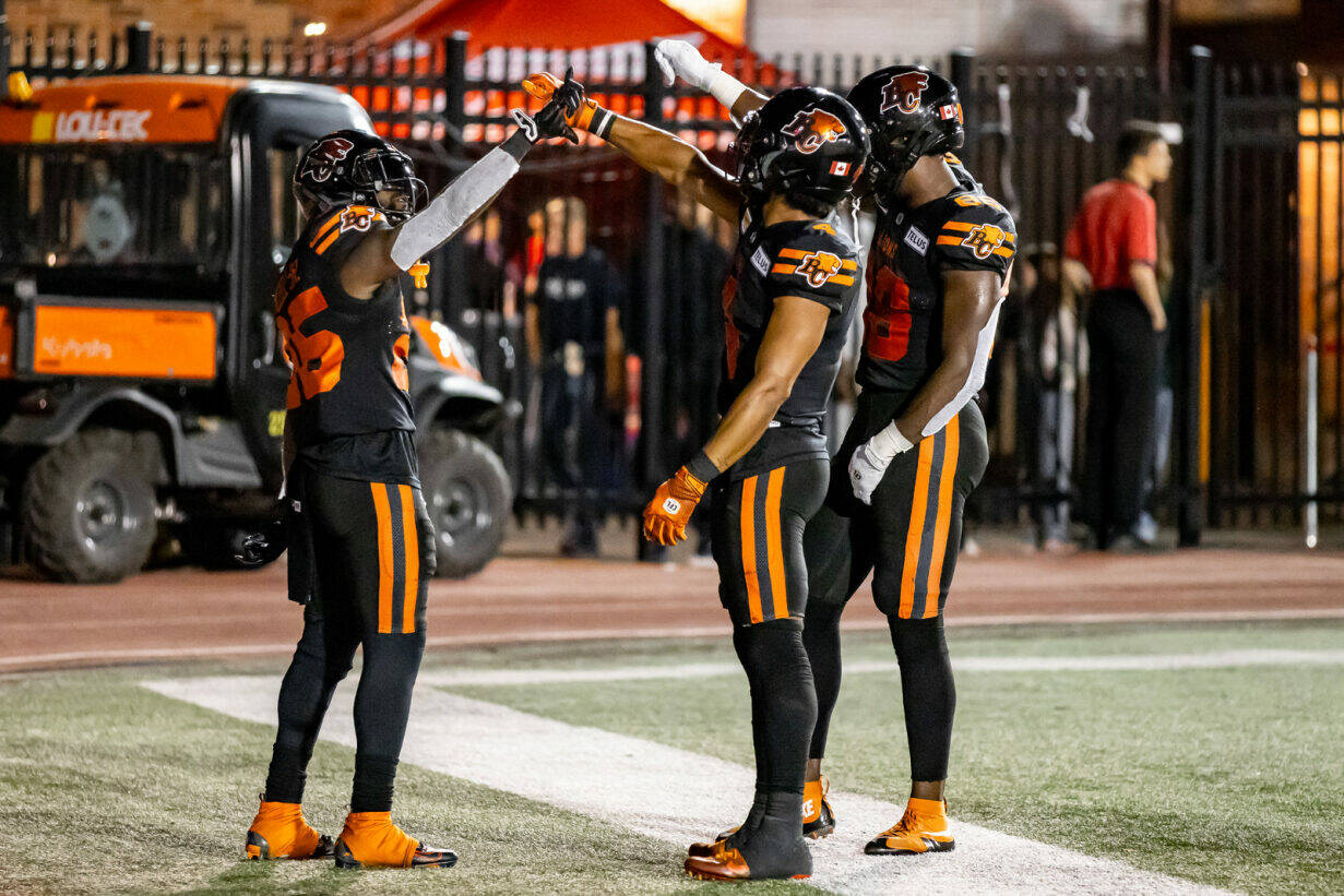 Lions running back Smoke Mizzell celebrates his seven-yard touchdown run with teammates Keon Hatcher (left) and Jevon Cottoy (right). The touchdown sealed the Lions 34-25 win against the Alouettes in Montreal on Friday. Photo by Steven Chang