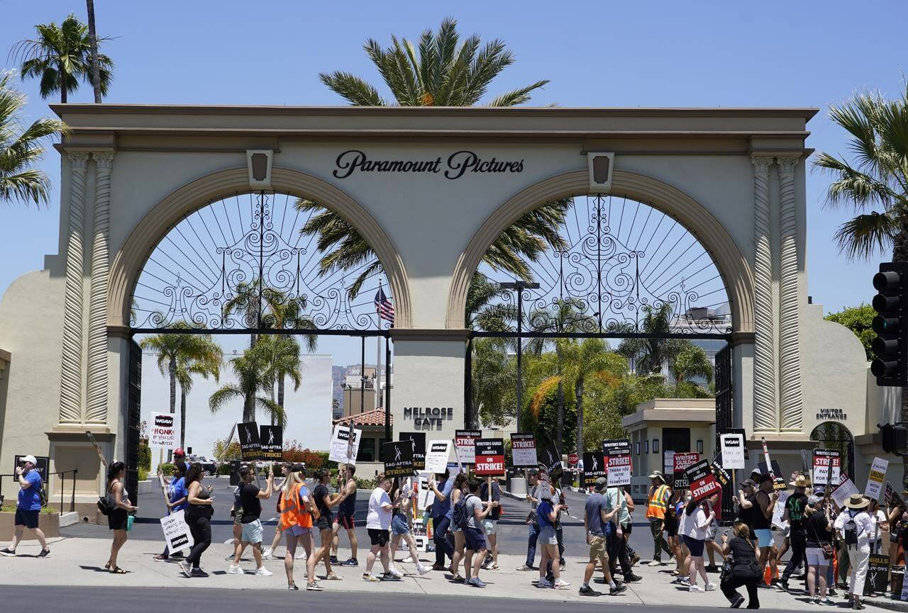 FILE - Striking writers and actors take part in a rally outside Paramount studios in Los Angeles on July 14, 2023. Hollywood productions and promotional tours around the world have been put on indefinite hold as actors and writers are on strike against big studios and streaming services. (AP Photo/Chris Pizzello, File)