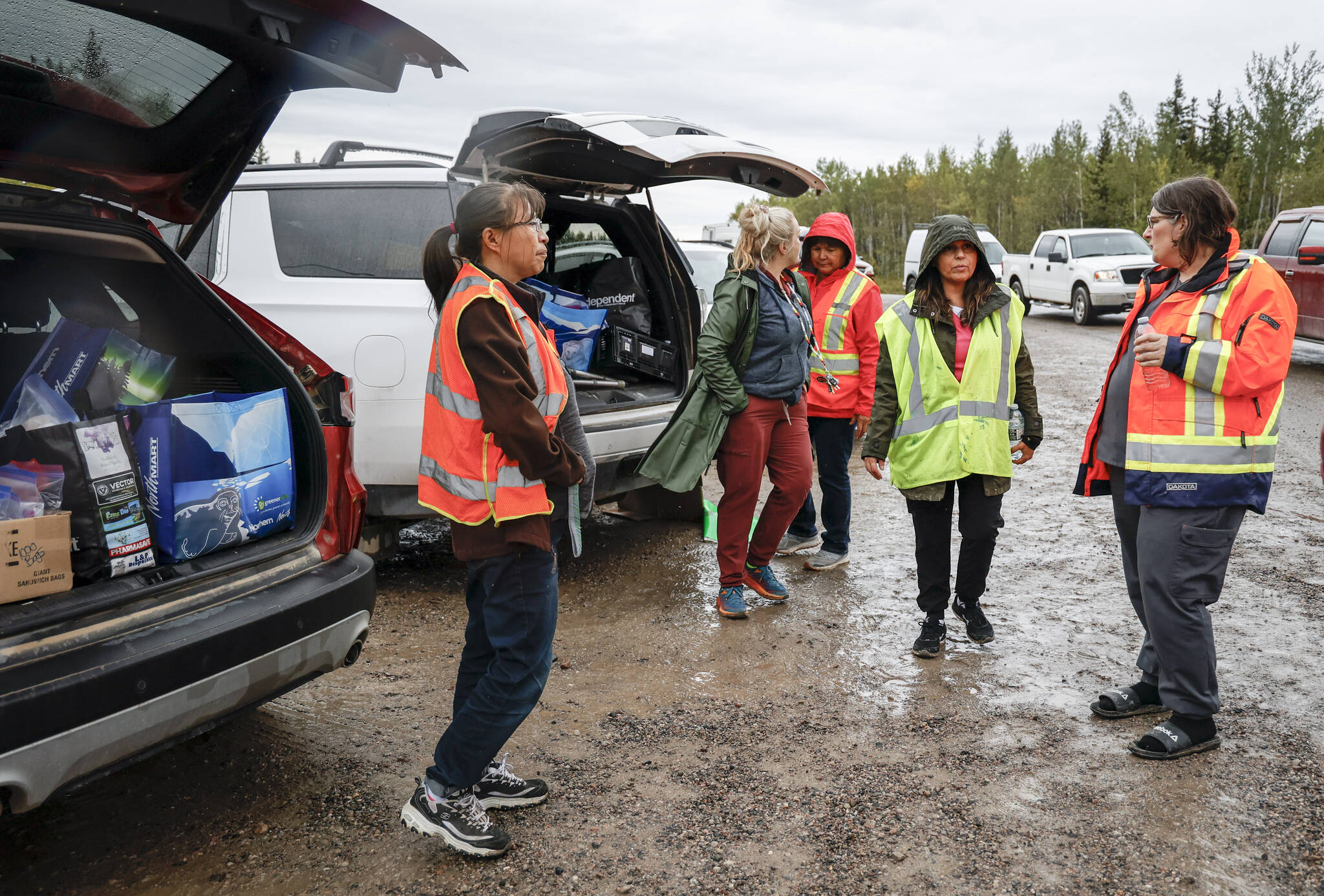 Volunteers prepare to hand out packed lunches to people lining up for fuel at Fort Providence, N.W.T., on the only road south from Yellowknife, Thursday, Aug. 17, 2023. Three weeks later, residents are returning to the city. THE CANADIAN PRESS/Jeff McIntosh