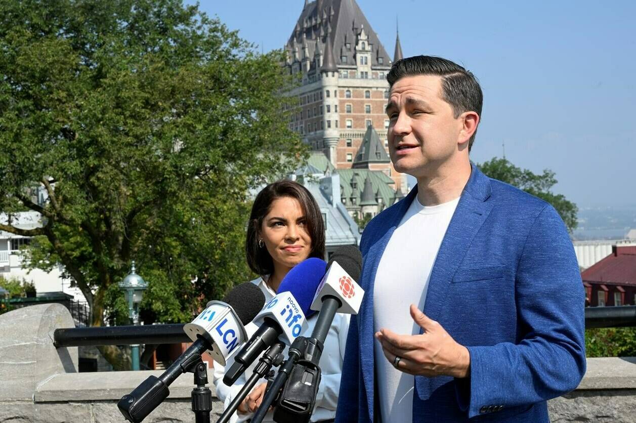 Conservative Leader Pierre Poilievre speaks during a news conference as his wife Anaida looks on, in Quebec City, Wednesday, Sept. 6, 2023. The Conservative Party is holding a three-day convention from Sept.7 to 9 in Quebec City. THE CANADIAN PRESS/Jacques Boissinot