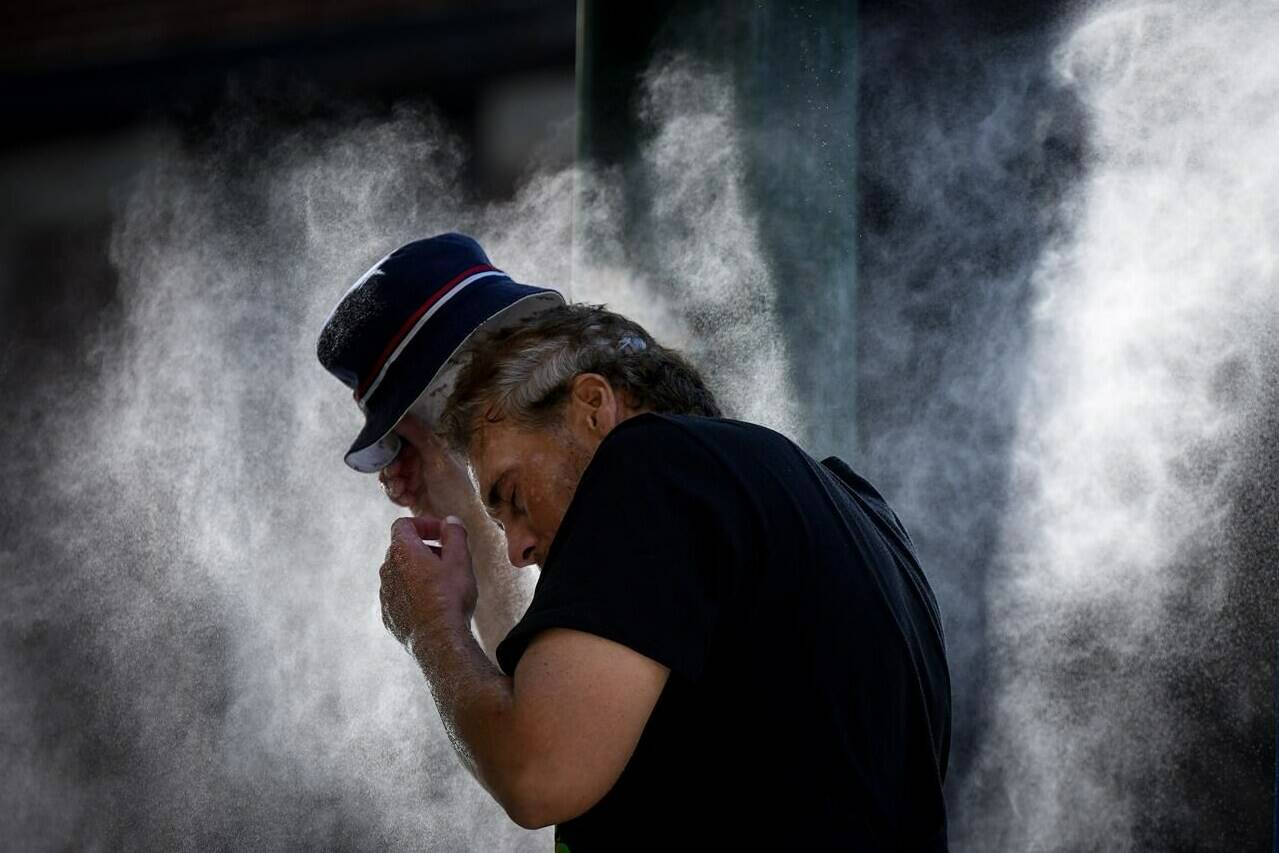 A new analysis has found that western Canada was one of the global hot spots in a summer that climate change made one of the warmest on record. A man cools off at a temporary misting station deployed by the city in the Downtown Eastside due to a heat wave, in Vancouver, Wednesday, Aug. 16, 2023. THE CANADIAN PRESS/Darryl Dyck