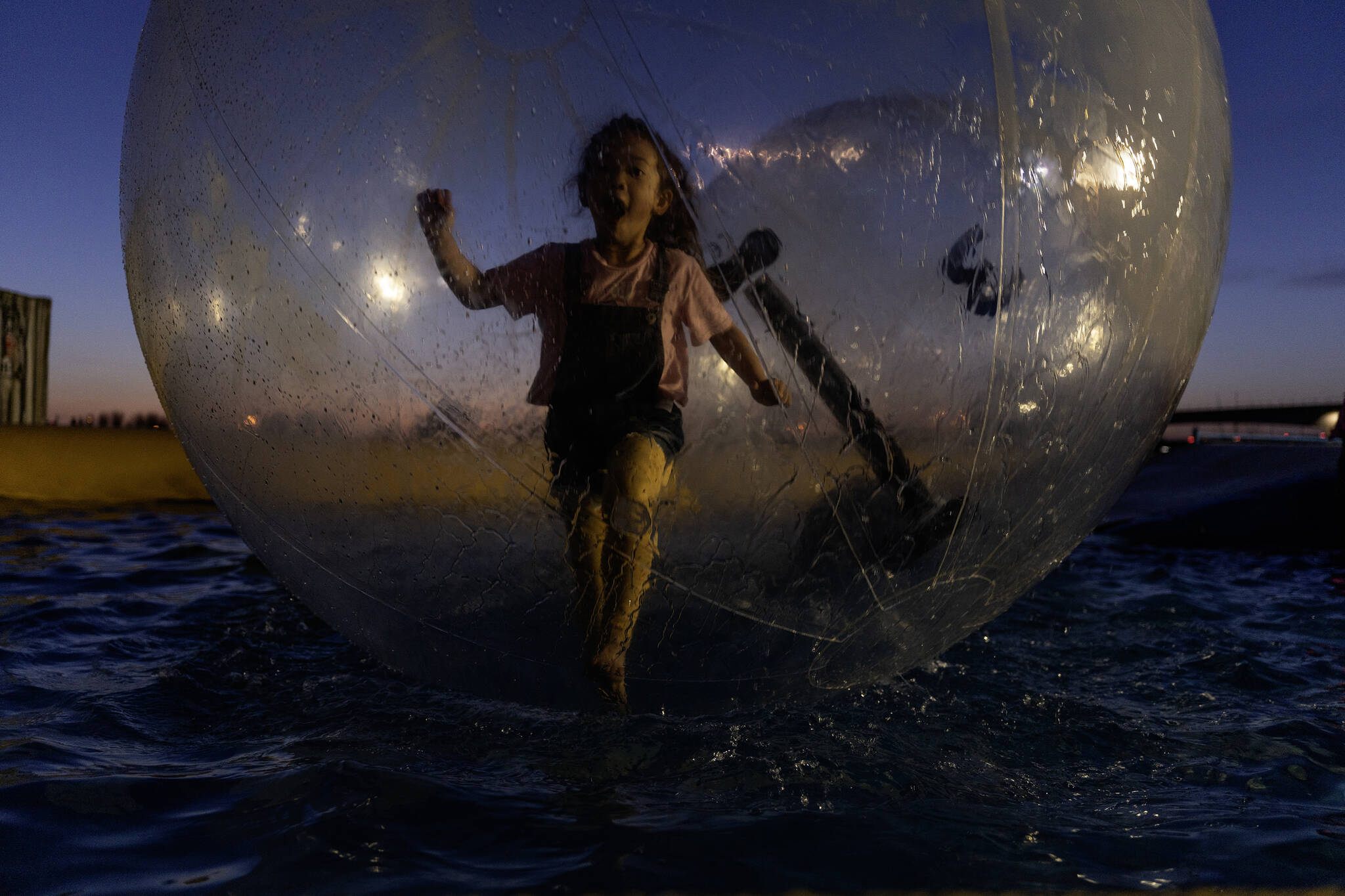 Mia Chen plays at the littles water walker area where she runs in an inflatable ball that float in a pool at the Richmond Night Market in Richmond, B.C., on Friday, April 28, 2023. Richmond is the most ethnically Chinese city in the world outside Asia. THE CANADIAN PRESS/Paige Taylor White