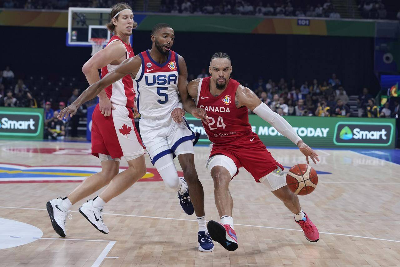 Canada forward Dillon Brooks (24) dribbles past U.S. forward Mikal Bridges (5) during the Basketball World Cup bronze medal game between the United States and Canada in Manila, Philippines, Sunday, Sept. 10, 2023. THE CANADIAN PRESS-AP-Michael Conroy