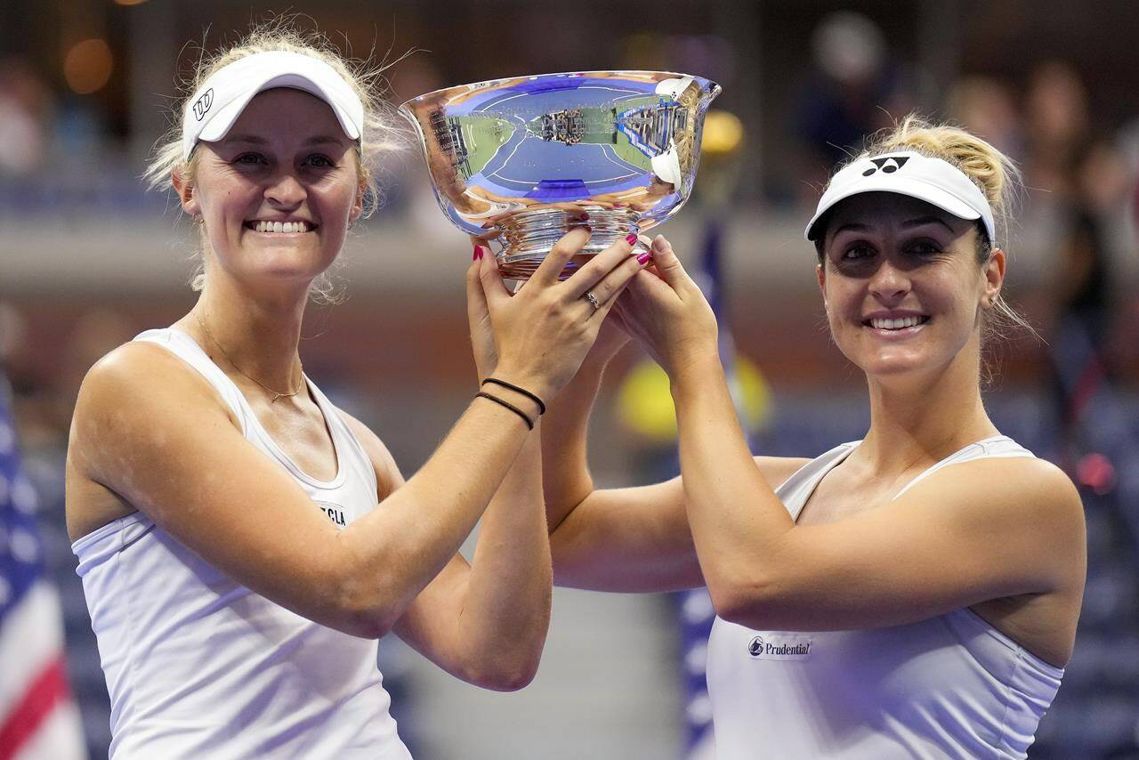 Erin Routliffe, of New Zealand, left, and Gabriela Dabrowski, of Canada, hold up the championship trophy after winning the women’s doubles final of the U.S. Open tennis championships against Laura Siegemund, of Germany, and Vera Zvonareva, of Russia, Sunday, Sept. 10, 2023, in New York.THE CANADIAN PRESS/AP/Manu Fernandez