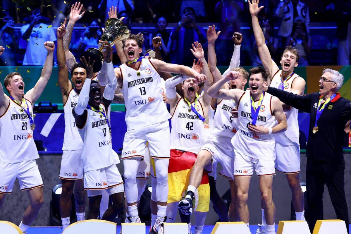 Head coach Gordon Herbert (far right) celebrates with his German team after they defeated Serbia 83-77 in the FIBA World Cup final. (NBA.com Photo)