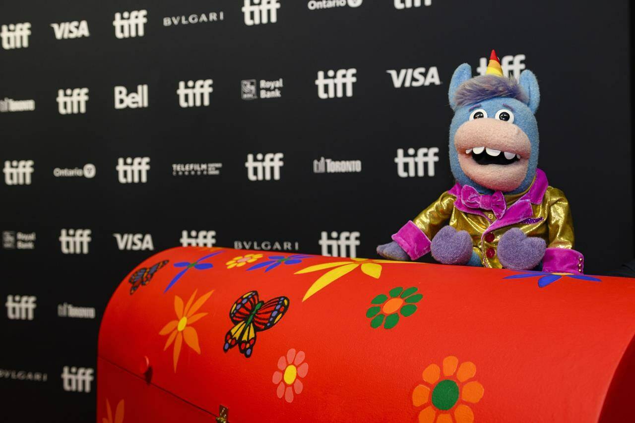 CBC’s Gary the Unicorn is photographed with the “Tickle Trunk” on the red carpet for the feature documentary film “Mr: Dressup: The Magic of Make-Believe” during the Toronto International Film Festival, Saturday, September 9, 2023. THE CANADIAN PRESS/Christopher Katsarov