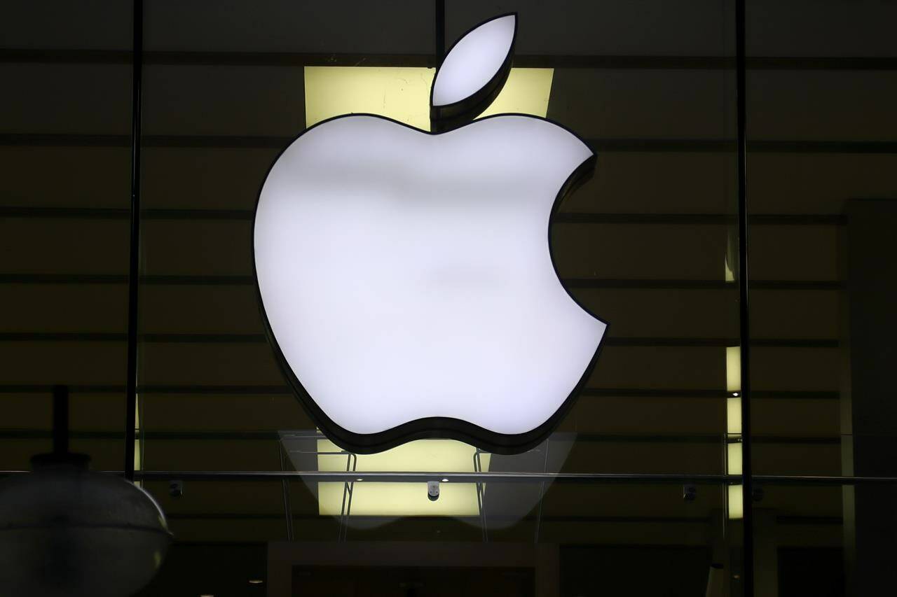 FILE - The Apple logo is illuminated at a store in the city center of Munich, Germany, Dec. 16, 2020. Apple is expected to take the wraps off its next iPhone on Tuesday, Sept. 12, 2023, during what has become an annual late summer rite aimed at giving more people more reasons to buy the technology trendsetter’s marquee product. (AP Photo/Matthias Schrader, File)