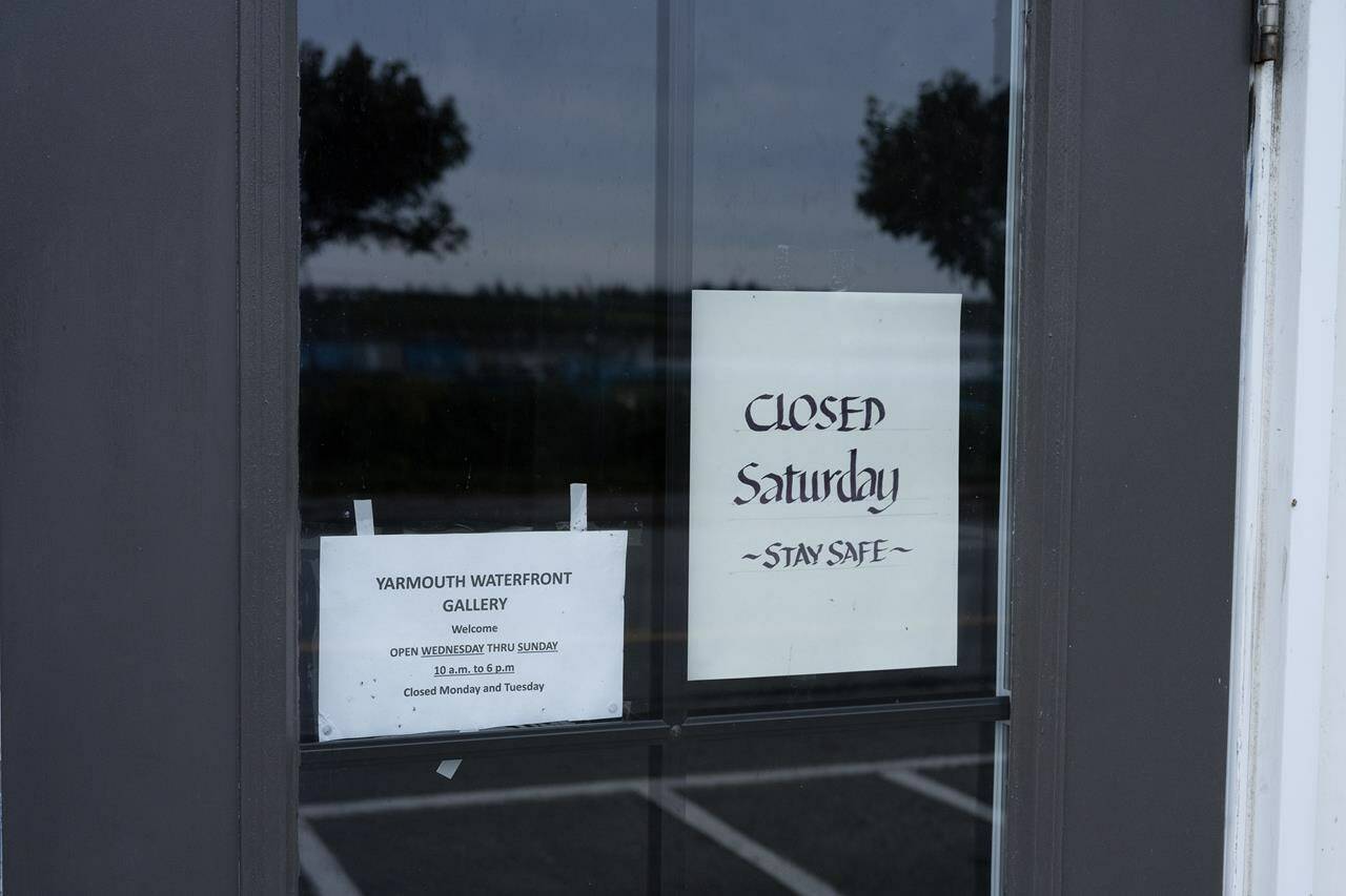 A sign at the Yarmouth Waterfront Gallery indicates it will be closed in anticipation of Hurricane Lee in Yarmouth, N.S. on Friday, Sept. 15, 2023. THE CANADIAN PRESS/Bill Curry