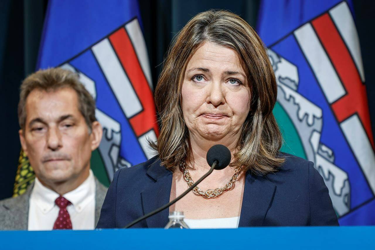 Alberta Premier Danielle Smith, right, becomes emotional as she speaks to the media about an E. coli outbreak at several Calgary daycares as Dr. Mark Joffe, Alberta chief medical officer of health, looks on in Calgary, Alta., Friday, Sept. 15, 2023. THE CANADIAN PRESS/Jeff McIntosh