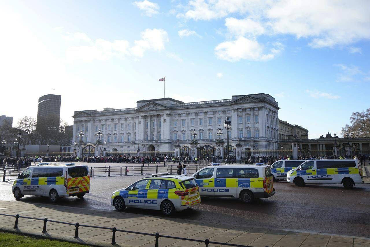 Police vehicles near Buckingham Palace in London, Monday, Jan. 9, 2023. London police arrested a 25-year-old man early Saturday morning (Sept. 16) after he allegedly climbed over a wall and entered the royal stables at Buckingham Palace. (AP Photo/Kirsty Wigglesworth)