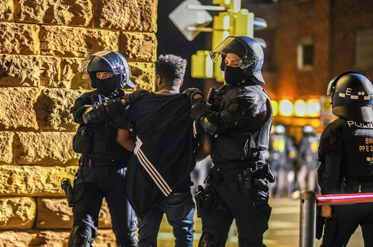 A man is taken away by police officers in Stuttgart, Baden-Württemberg, Germany, on Saturday, Sept. 16, 2023, after clashes at a gathering of Eritrean groups. (Jason Tschepljakow/dpa via AP)