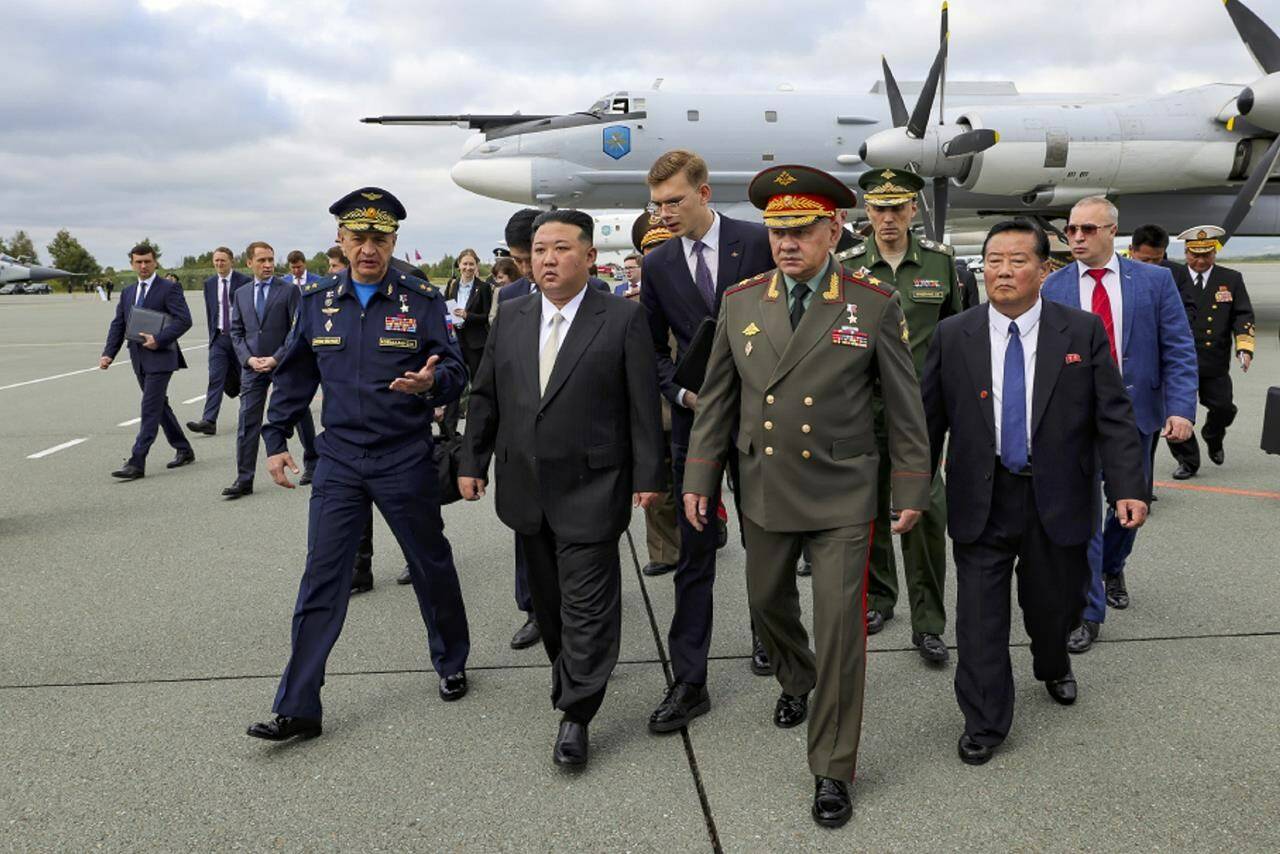 In this photo released by Russian Defense Ministry Press Service, North Korea’s leader Kim Jong Un, center, and Russian Defense Minister Sergei Shoigu, foreground right, arrive to inspect Russian warplanes at the Vladivostok International airport in Vladivostok, Russian Far East Saturday, Sept. 16, 2023. (Russian Defense Ministry Press Service via AP)