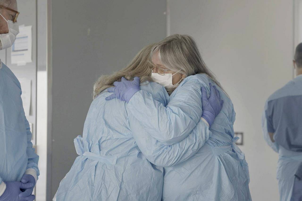 Relatives of Maurice “Mo” Miller, Mary Miller-Duffy, his sister, center left, and Sue Duffy, her wife, embrace after seeing his body at NYU Langone Health in New York on Tuesday, Sept. 12, 2023. For a history-making 61 days and despite a brief rejection blip, a pig’s kidney worked normally inside his brain-dead body. (AP Photo/Shelby Lum)