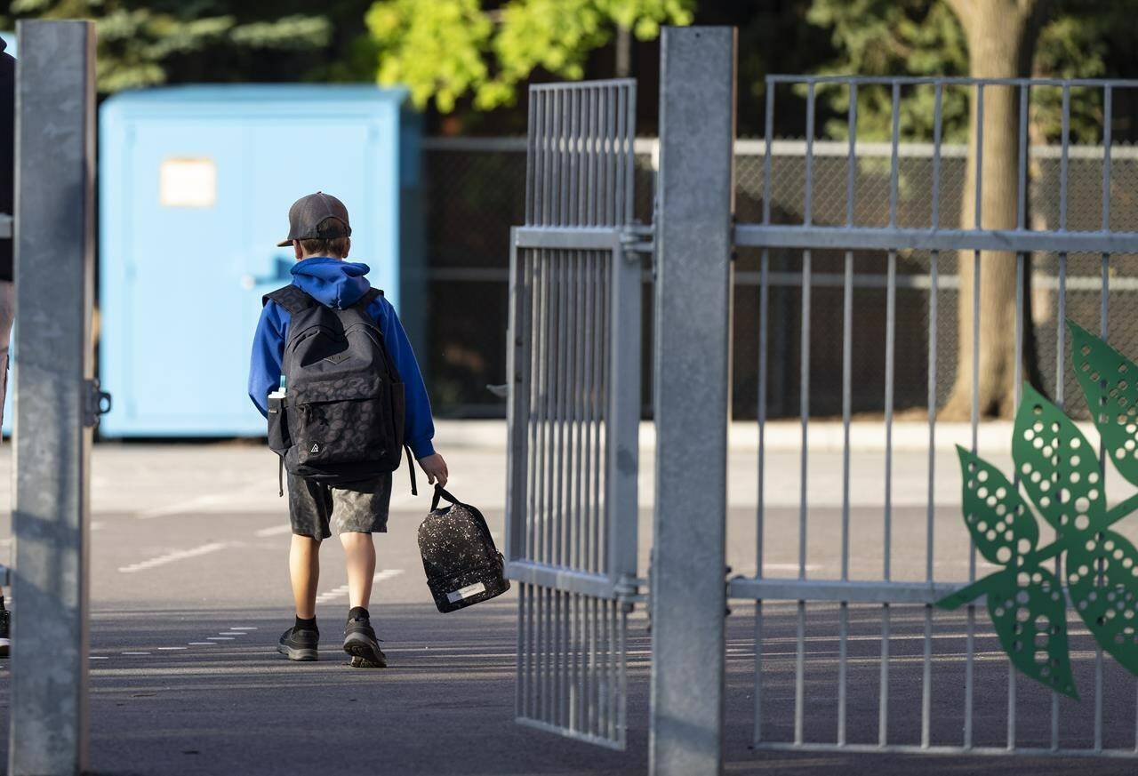 A elementary student arrives for his first day back to school in Montreal, Monday, Aug. 28, 2023. Returning to school in September can be a “mixed picture” for students as some deal with higher levels of anxiety as change can be a stressful situation. THE CANADIAN PRESS/Christinne Muschi
