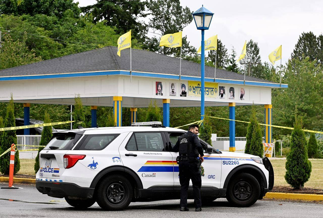 The son of Sikh community leader Hardeep Singh Nijjar says his father was meeting regularly with Canadian intelligence officers in the months before he was shot dead in British Columbia, in a killing Prime Minister Justin Trudeau says has been credibly linked to India. Police officers attend the scene of a shooting outside of the Guru Nanak Sikh Gurdwara Sahib temple, in Surrey, B.C., Monday, June 19, 2023. THE CANADIAN PRESS/Jennifer Gauthier