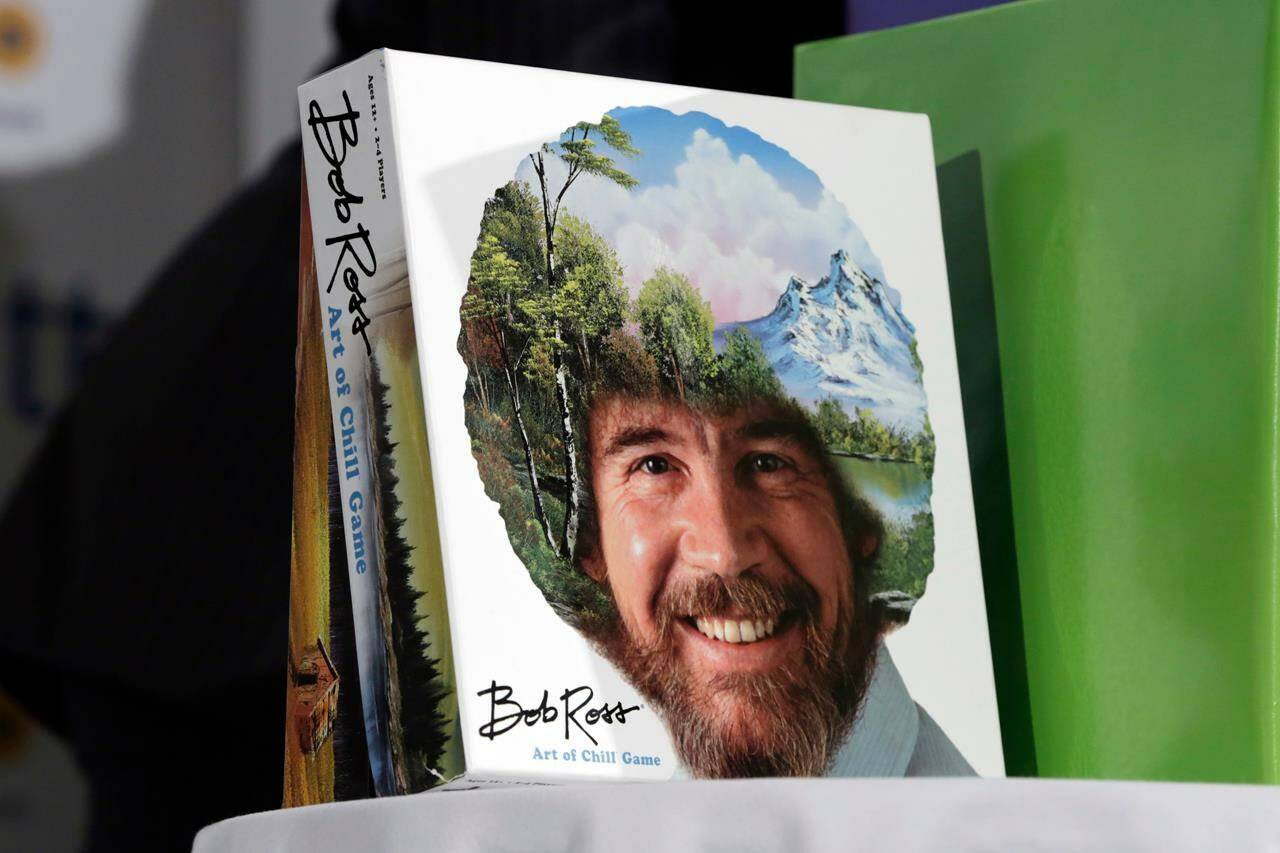 FILE - In this April 26, 2018 file photo, The Bob Ross “Art of the Chill Game,” by Big G Creative, is displayed at the TTPM 2018 Spring Showcase, in New York. Ross was known for his unpretentious approach to painting on his long-running show, “The Joy of Painting,” but now the painting he completed on his first show in 1983 is for sale for nearly $10 million. Minneapolis gallery owner Ryan Nelson calls it the ‘rookie card’ for Ross. (AP Photo/Richard Drew)
