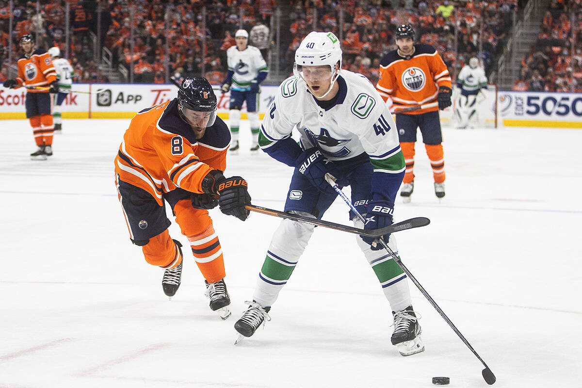 Vancouver Canucks’ Elias Pettersson (40) battles for the puck during first period NHL action in Edmonton on Wednesday, October 13, 2021.THE CANADIAN PRESS/Jason Franson