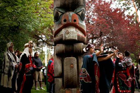 Women dance during the Abyas song to cleanse and bless the ground for the cedar mortuary pole replica carved by Mungo Martin in 1955 was removed from Thunderbird Park during a commemorative ceremony on the grounds of the Royal B.C. Museum in Victoria, B.C., on Wednesday, June 5, 2019. (THE CANADIAN PRESS/Chad Hipolito)