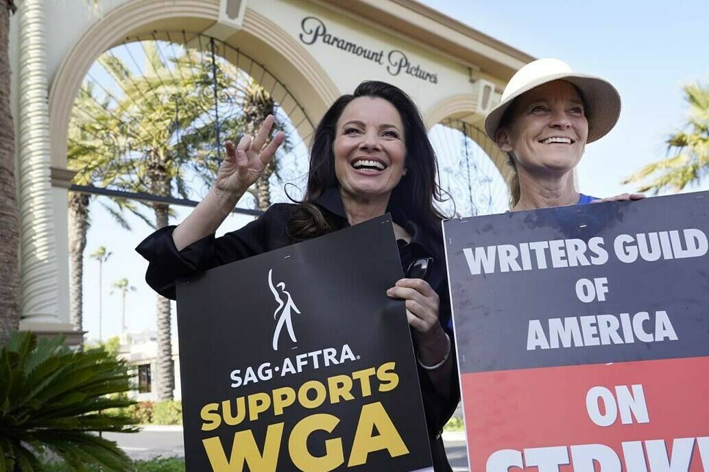 FILE - Fran Drescher, left, president of SAG-AFTRA, and Meredith Stiehm, president of Writers Guild of America West, pose together during a rally by striking writers outside Paramount Pictures studio in Los Angeles on May 8, 2023. (AP Photo/Chris Pizzello, File)