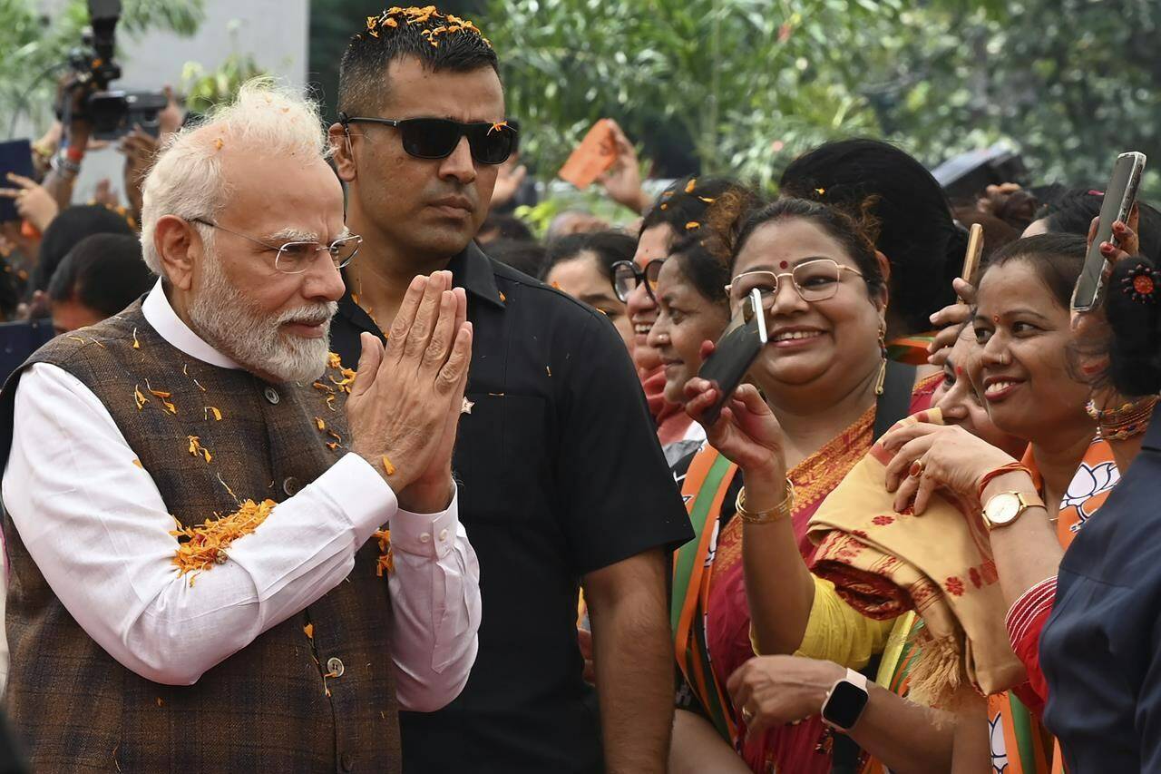 Indian Prime Minister Narendra Modi is welcomed at the Bharatiya Janata Party headquarters, where he was felicitated a day after the women’s reservation bill was passed by the Indian Parliament in New Delhi, Friday, Sep. 22, 2023. (AP Photo/STR)