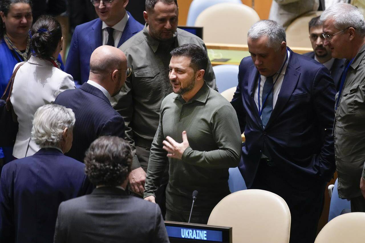 Ukrainian President Volodymyr Zelenskyy, center, greets people before the start of the 78th session of the United Nations General Assembly at United Nations headquarters, Tuesday, Sept. 19, 2023. (AP Photo/Seth Wenig)