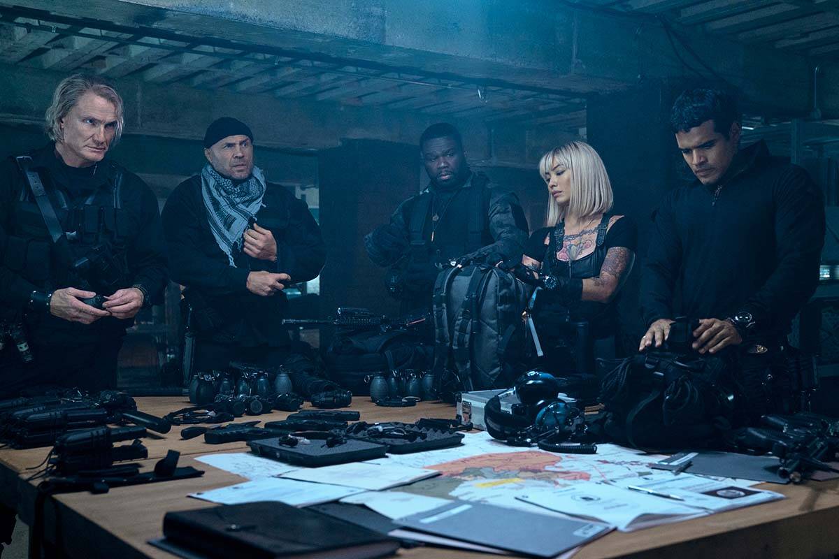 This image released by Lionsgate shows Dolph Lundgren, from left, Randy Couture, Curtis Jackson, Levy Tran and Jacob Scipio in a scene from “The Expend4bles.” (Lionsgate via AP)