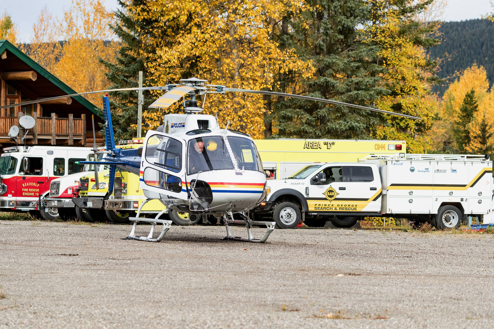 A police helicopter prepares for takeoff from a staging area at Purden Lake Resort near the site of a helicopter crash, east of Prince George, B.C., on Tuesday, Sept. 26, 2023. THE CANADIAN PRESS/James Doyle