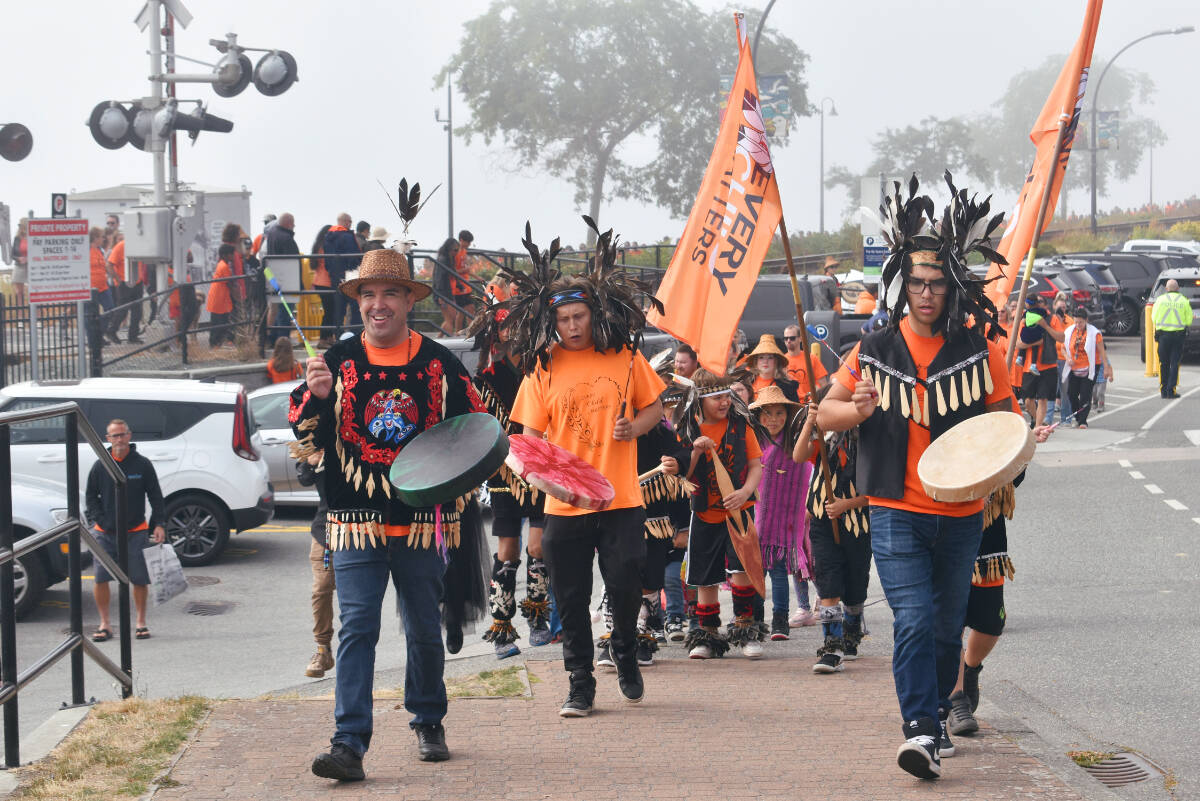 Chief Harley Chappell and SFN youth drummers, singers and dancers lead the walk from Grand Chief Bernard Robert Charles Plaza to Memorial Park to mark the second annual National Day for Truth and Reconciliation, Sept. 30, 2022. (Alex Browne file photo)