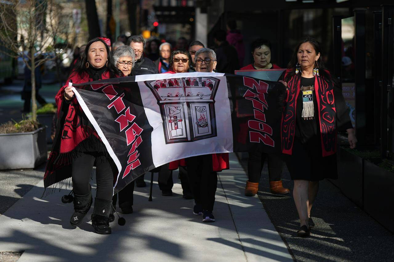 Members of the Gitxaala Nation, including Chief Councillor Linda Innes, front right, march to B.C. Supreme Court in Vancouver, B.C., Monday, April 3, 2023. THE CANADIAN PRESS/Darryl Dyck