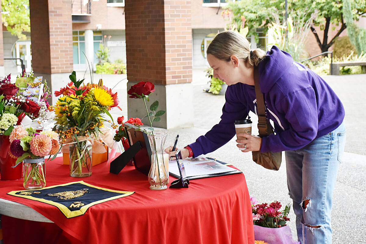 Ashleigh Daniels, a police officer in Coquitlam signs the book of condolences for fallen Ridge Meadows RCMP Const. Rick O’Brien. (Colleen Flanagan/The News)