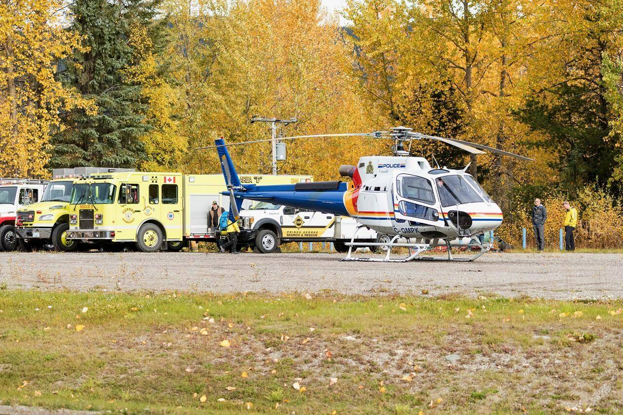 Forest products firm Canfor says hired contractors on their way to conduct field survey work for the company were on board a helicopter that crashed outside Prince George, B.C., killing two and injuring four. A police helicopter prepares for takeoff from a staging area at Purden Lake Resort near the site of the crash on Tuesday, Sept. 26, 2023. THE CANADIAN PRESS/James Doyle