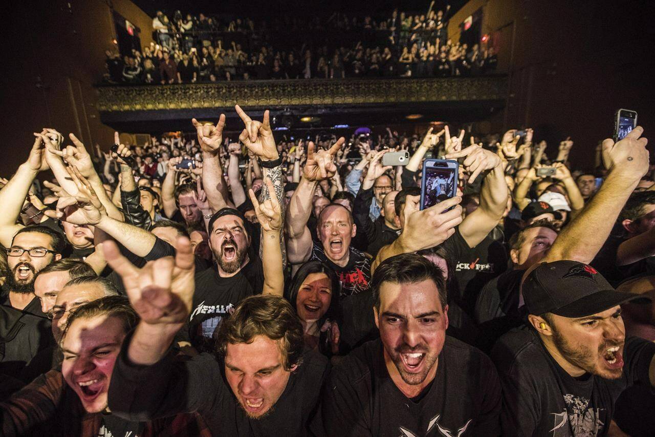Fans cheer as Metallica plays at the Opera House, a small venue with a 950 person capacity, in Toronto, Tuesday November 29, 2016. Live Nation says it has launched a new program that pledges to no longer take a cut of musician's merchandise sales at some of its club venues. THE CANADIAN PRESS/Mark Blinch