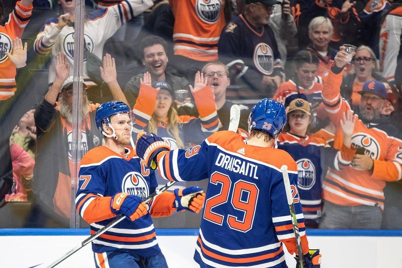 Edmonton Oilers’ Connor McDavid (97) and Leon Draisaitl (29) celebrate an overtime goal against the Vancouver Canucks during overtime NHL pre season action in Edmonton, Wednesday, Sept. 27, 2023. THE CANADIAN PRESS/Jason Franson