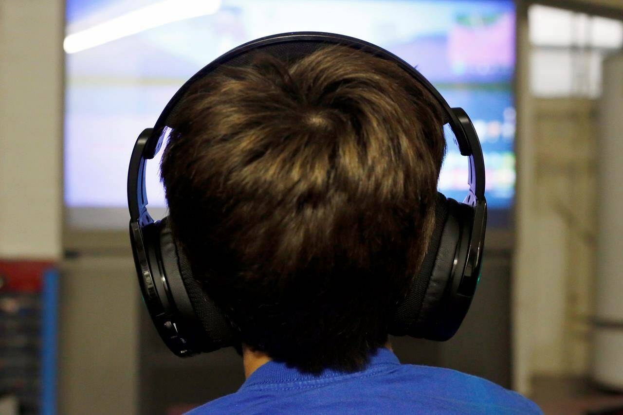 The maker of the popular video game Fortnite has begun compensating claims in a $2.75-million settlement to a Canadian class-action lawsuit over the inclusion of controversial “loot boxes” in the game. A boy plays “Fortnite” at his Chicago home on Oct. 6, 2018. THE CANADIAN PRESS/AP, Martha Irvine