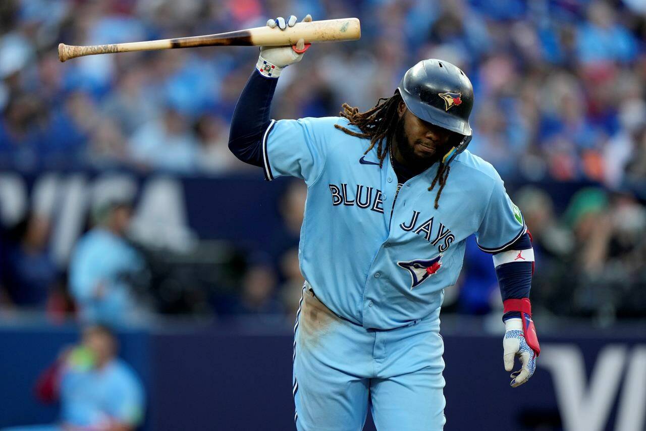 Toronto Blue Jays’ Vladimir Guerrero Jr. (27) gestures with his bat after popping out during tenth inning American League MLB baseball action against the Tampa Bay Rays, in Toronto, Saturday, Sept. 30, 2023. THE CANADIAN PRESS/Frank Gunn