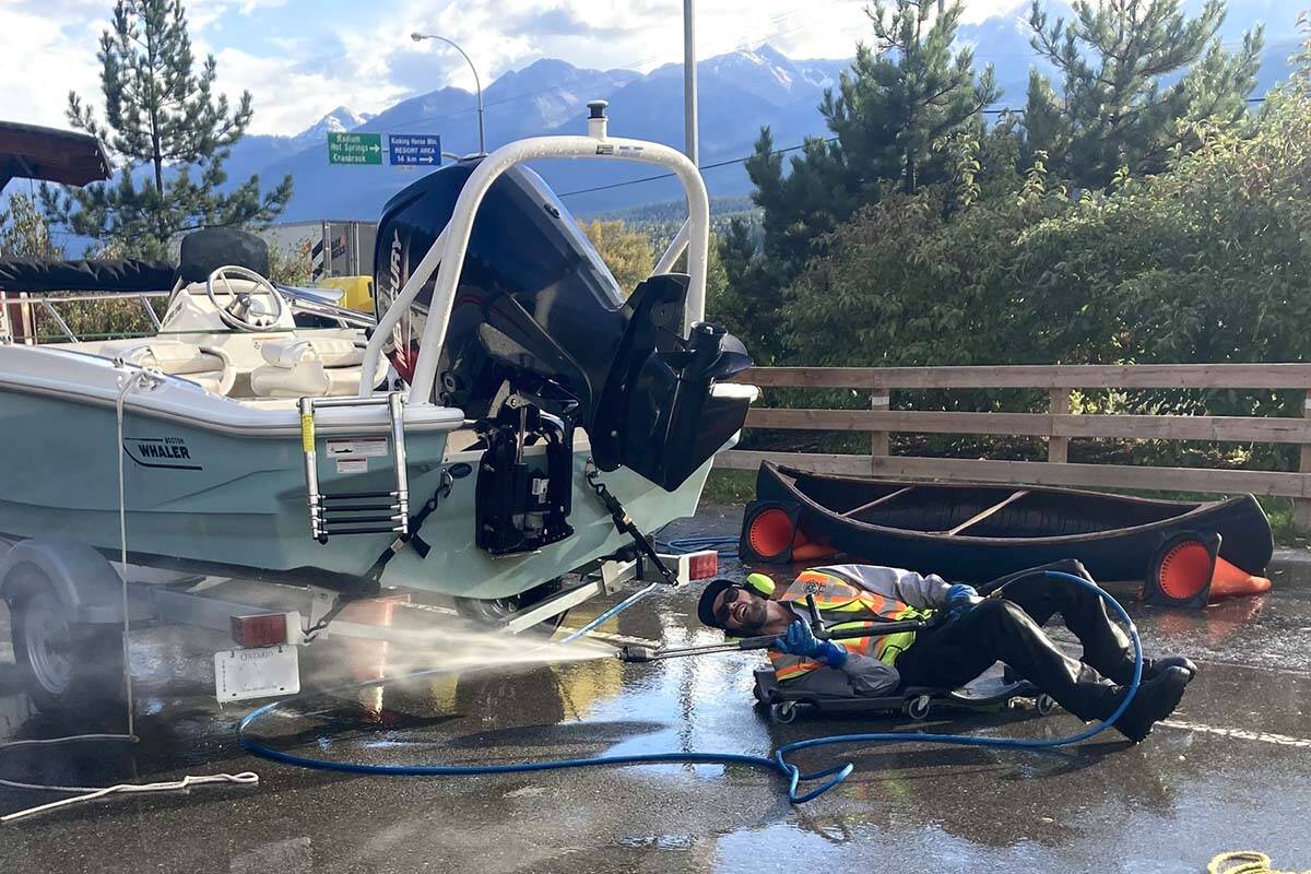 Crew members at a watercraft inspection site in Golden decontaminated a boat from Ontario that had invasive mussels on board. (Conservation Officer Service/Facebook)
