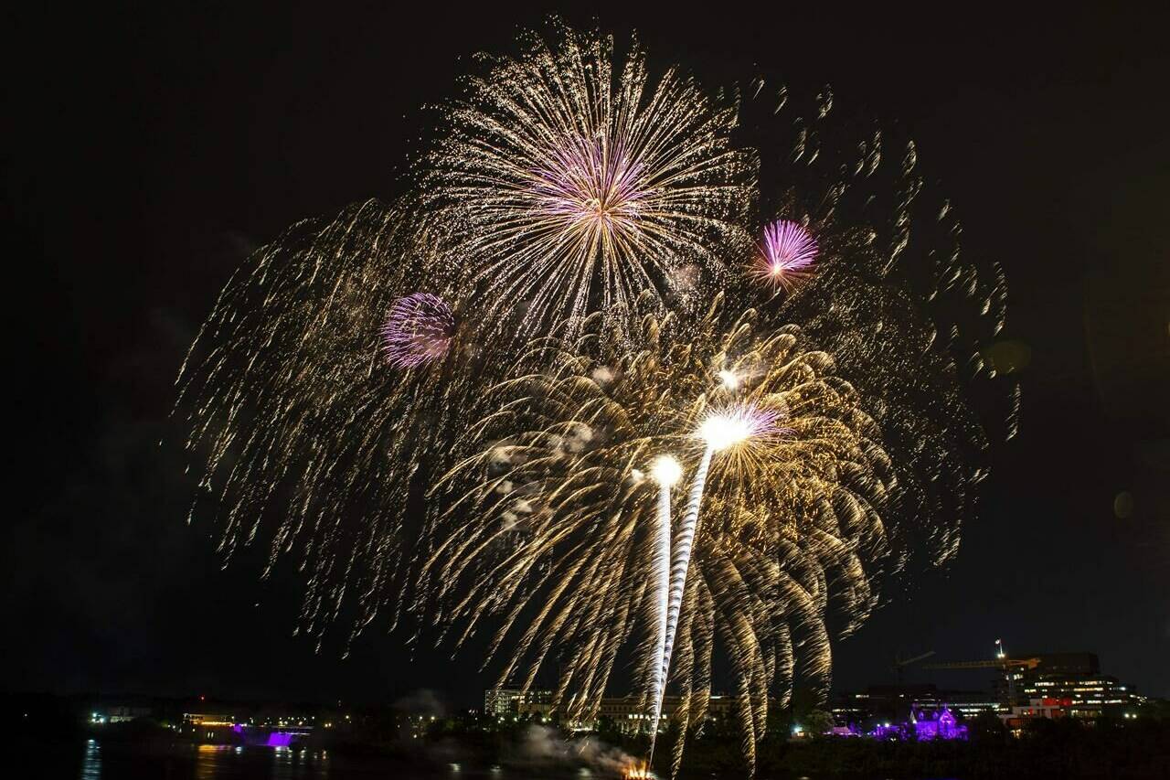 Fireworks explode in the air above the Ottawa River to celebrate the Queen’s Platinum Jubilee, in Ottawa on June 2, 2022. THE CANADIAN PRESS/Justin Tang