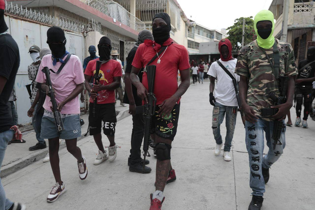 Armed members of “G9 and Family” march in a protest against Haitian Prime Minister Ariel Henry in Port-au-Prince, Haiti, Tuesday, Sept. 19, 2023. (AP Photo/Odelyn Joseph)