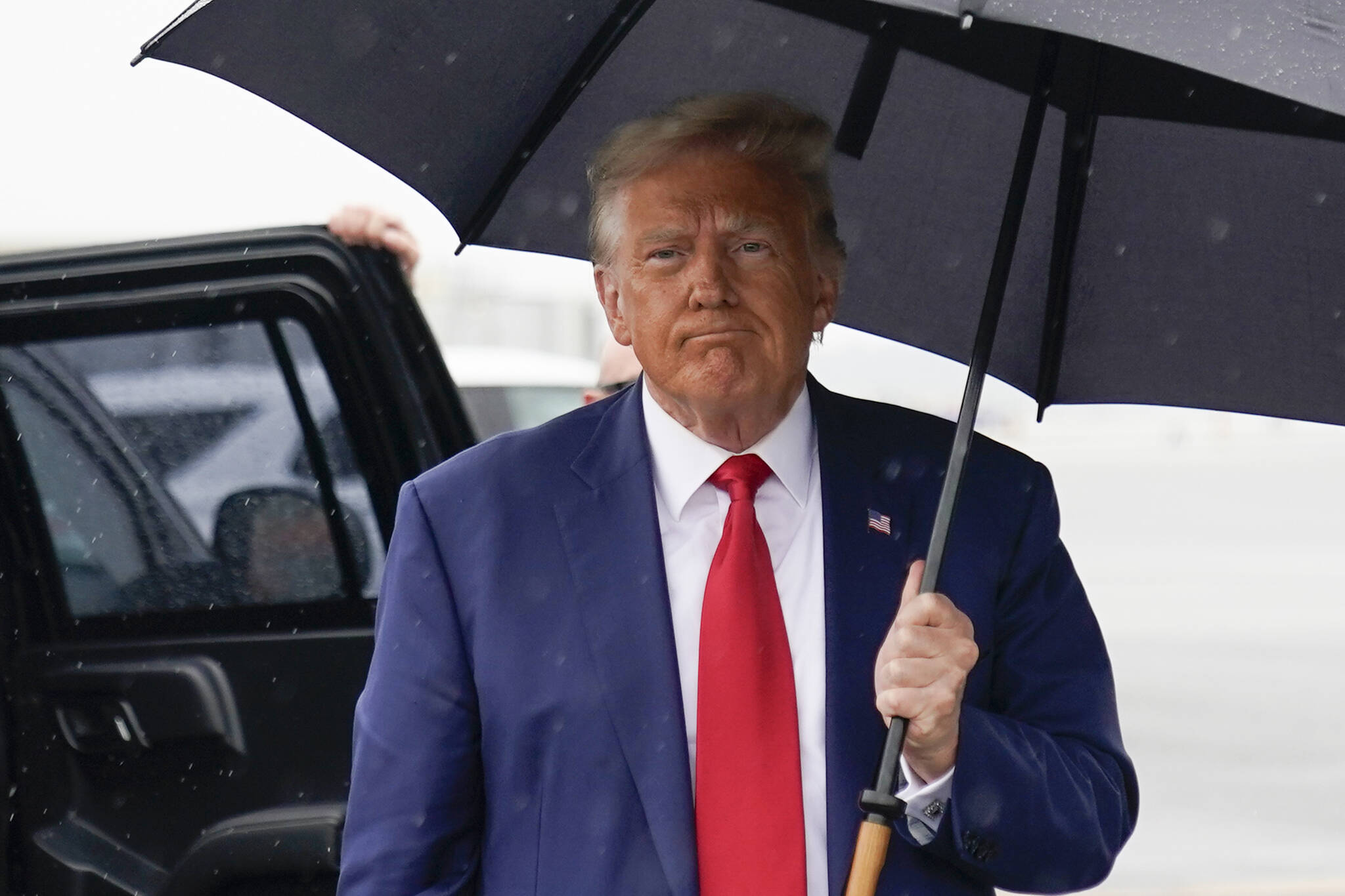 Former President Donald Trump walks over to speak with reporters before he boards his plane at Ronald Reagan Washington National Airport on Aug. 3 in Arlington, Va., after facing a judge on federal conspiracy charges that allege he conspired to subvert the 2020 election. (AP Photo/Alex Brandon)