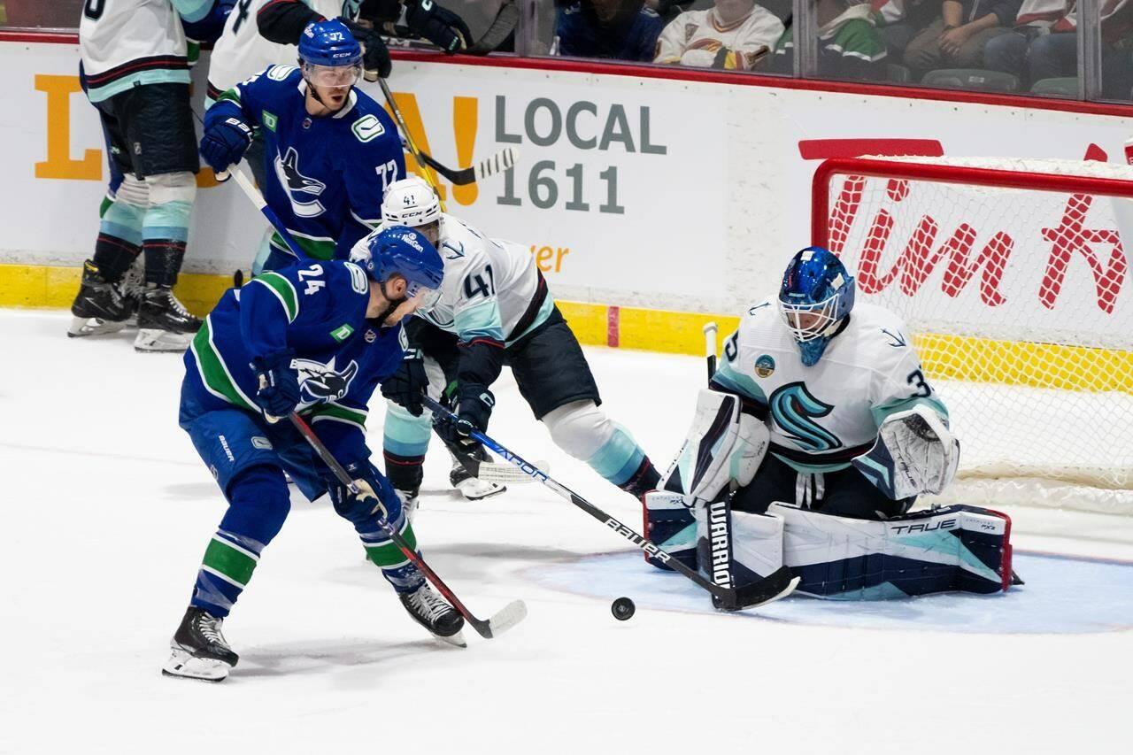 Vancouver Canucks’ Pius Suter (24) takes a shot on Seattle Kraken goaltender Joey Daccord (35) during the second period of preseason NHL action in Abbotsford, B.C. on Wednesday, Oct. 4, 2023. THE CANADIAN PRESS/Ethan Cairns