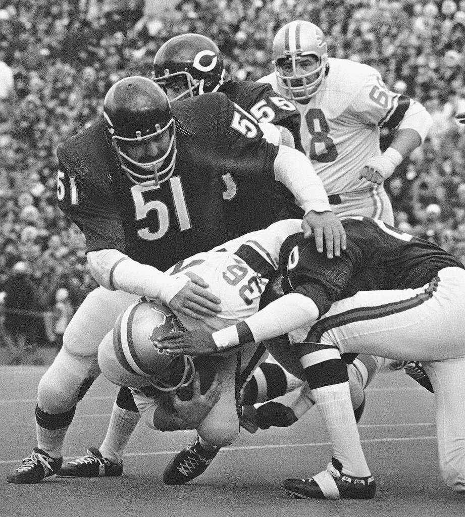FILE - Chicago Bears’ Dick Butkus (51), Doug Buffone (55) and Joe Taylor (20) stop Detroit Lions running back Steve Owens (36) during an NFL football game Nov. 21, 1971, in Chicago. Butkus, a fearsome middle linebacker for the Bears, has died, the team announced Thursday, Oct. 5, 2023. He was 80. According to a statement released by the team, Butkus’ family confirmed that he died in his sleep overnight at his home in Malibu, Calif. (AP Photo/Fred Jewell)